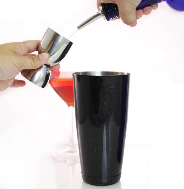 rounded-stainless-steel-jigger-35-505-ml-use.jpg BarProducts.com BarConic® Stainless Steel Rounded Jigger- 35ml/50ml